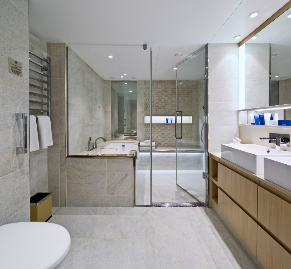  The large master bathroom features a spacious glass-enclosed shower, double-sink vanity and heated floors