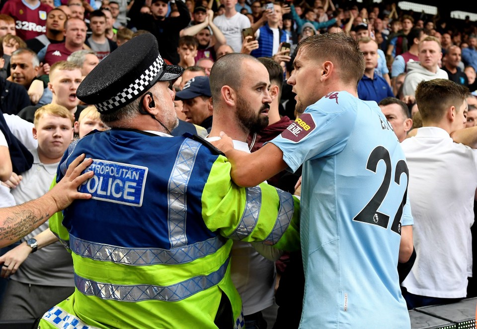  Villa centre-back Bjorn Engels is held back by a police officer at full-time