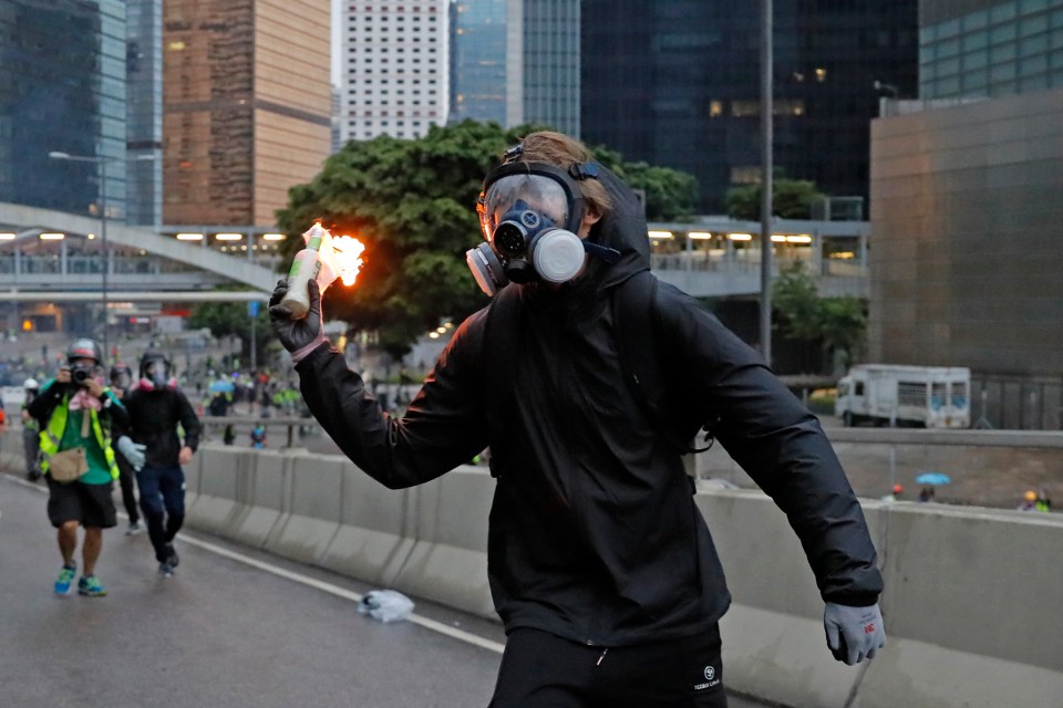  A protester brandishes a Molotov cocktail, which has become the weapon of choice against Chinese state authorities