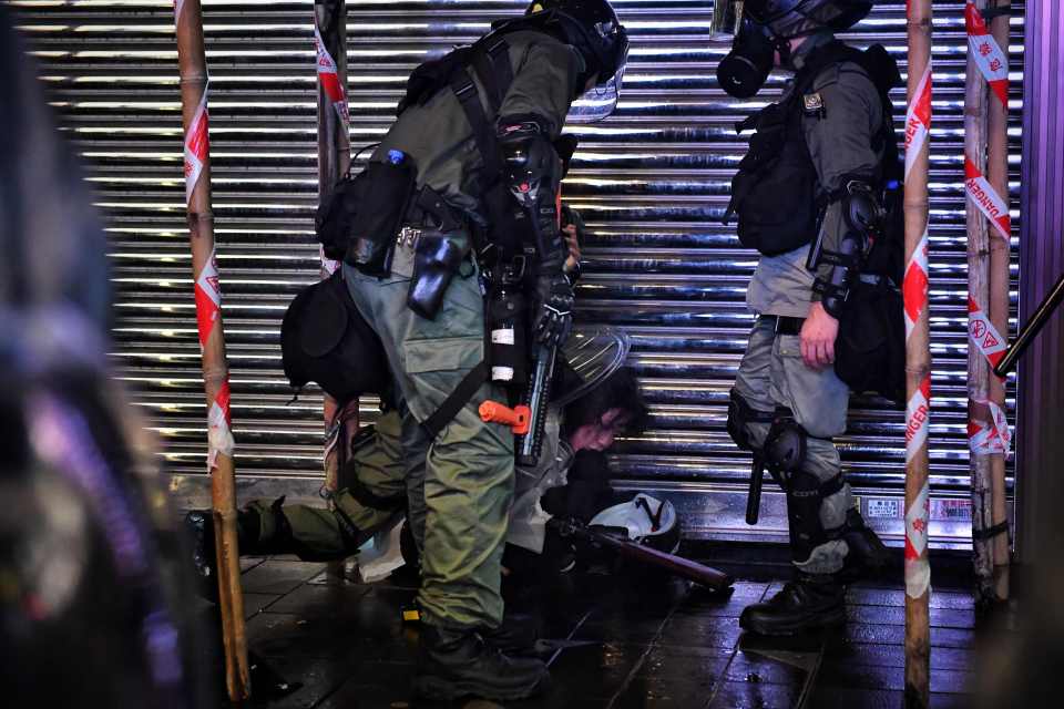  A riot cop detain a protester in Causeway Bay