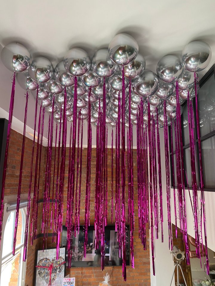  Tommy covered the ceiling with silver and pink balloons