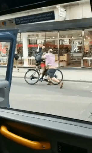  The pair lunge at each other in the middle of the street