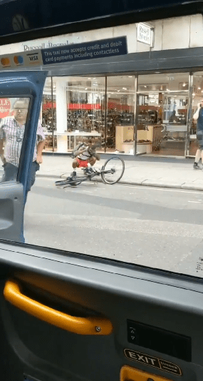  The cyclist drops to the ground and picks up his bike