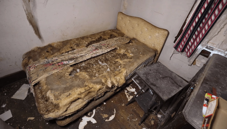  The filthy remains of a bed lie in one of the home's bedrooms