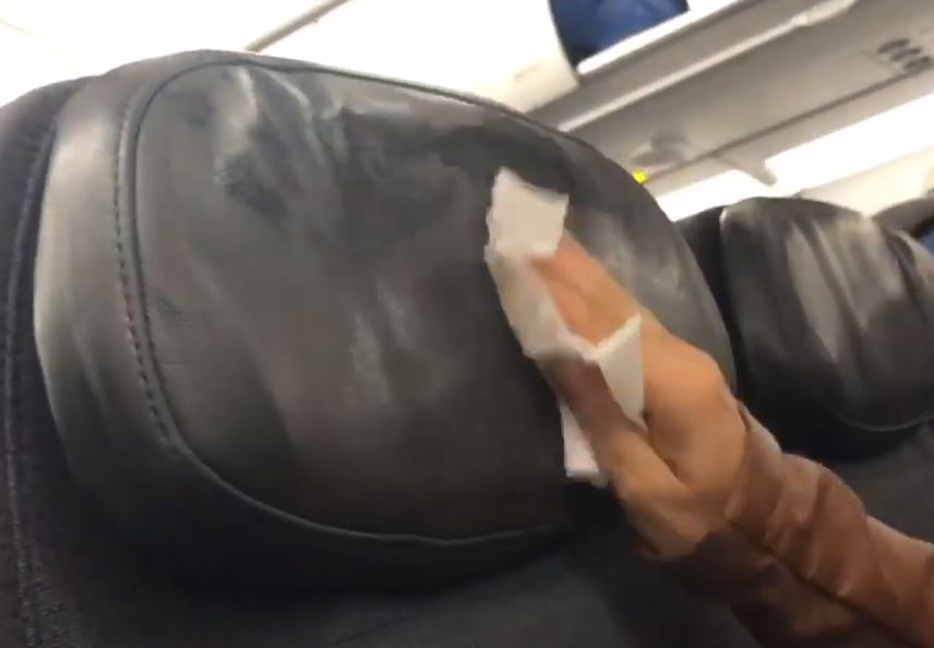  A passenger filmed herself cleaning a plane head rest with a wipe