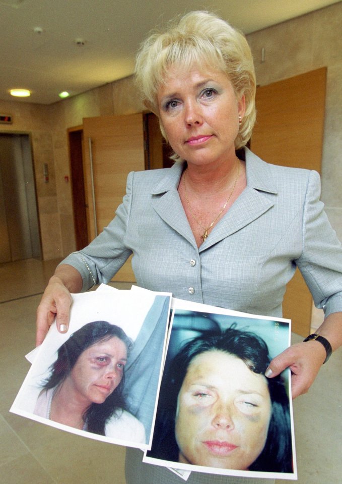  Margaret Moore seated inside the Aix en Provence courthouse May 3 with pictures showing her briused face