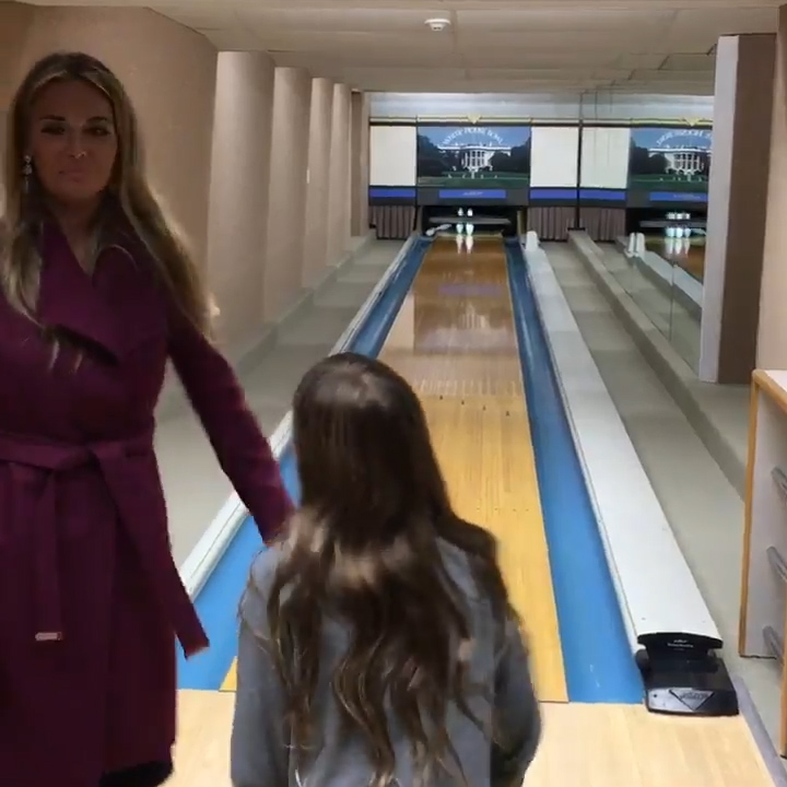 Vanessa stands beside daughter Madison inside the basement bowling room