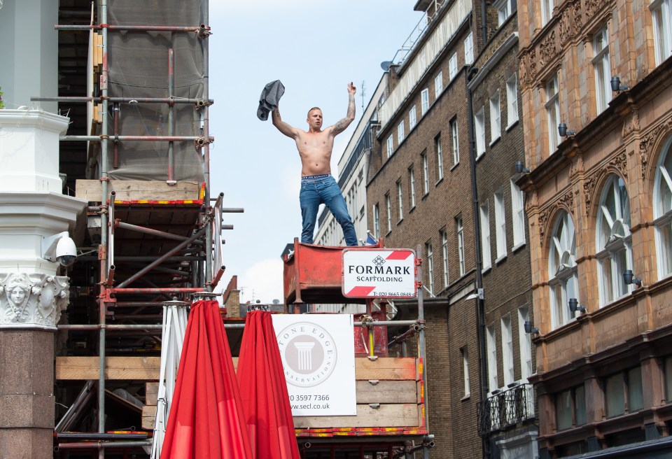  A man climbs atop scaffolding in the capital