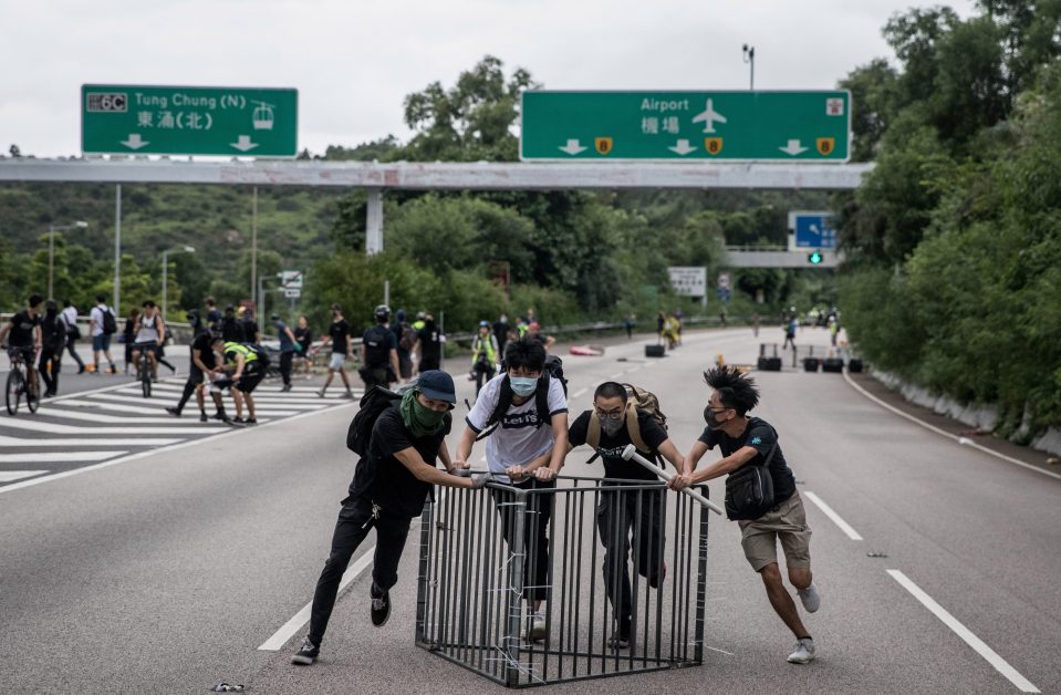  People make a barricade on the freeway leading to the airport in Hong Kong