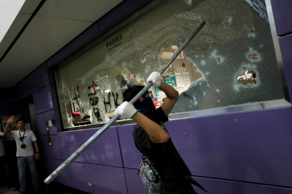  Anti-extradition bill protesters smash the Mass Transit Railway (MTR) facility as they accuse the railway operator of helping the government to catch demonstrators