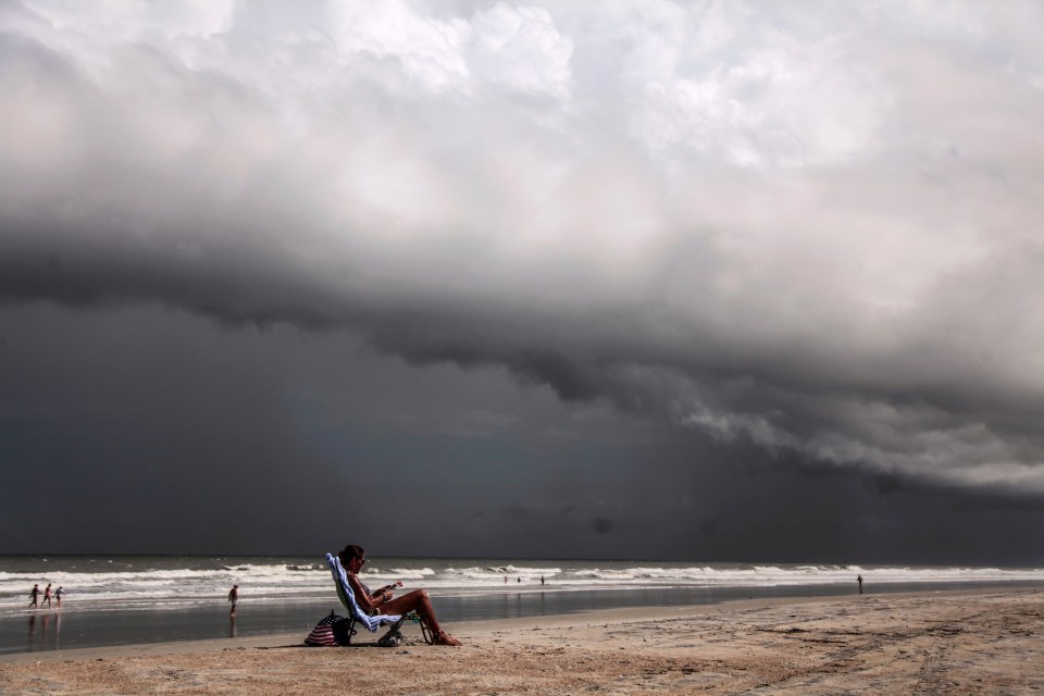  Tricia Cheshire, a resident of Amelia Island sunbathes for the last few minutes before storms hit the coast in Jacksonville, Florida