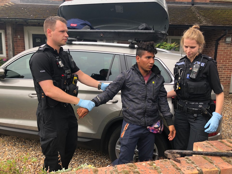  The man, from Egypt, is led away by police officers in Newbury, Berkshire