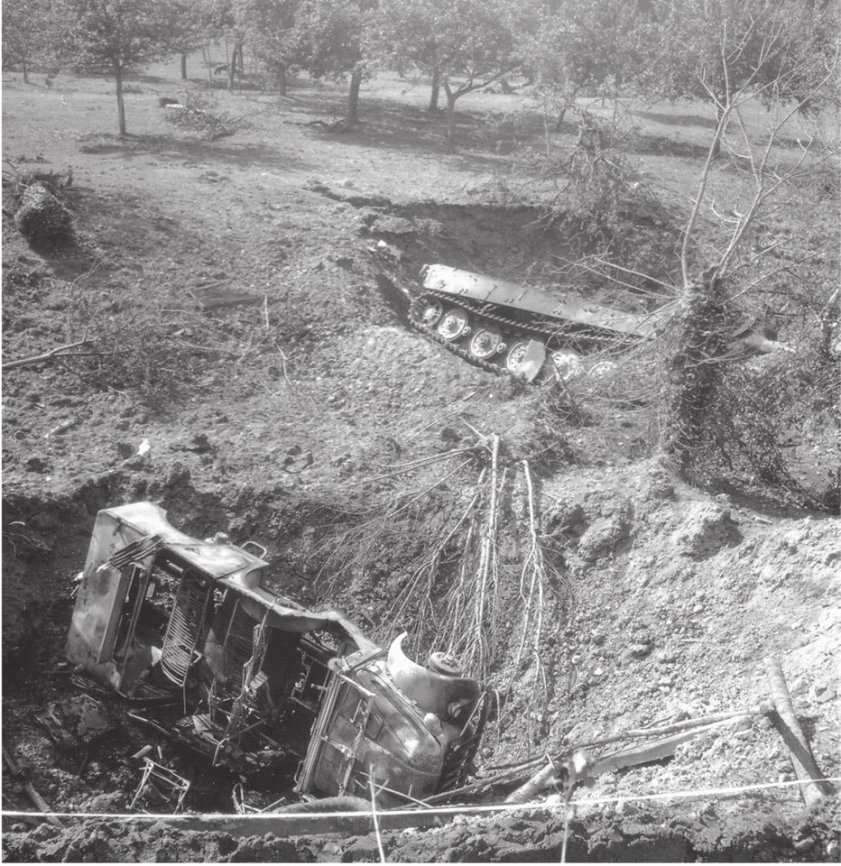  A German Tiger II tank and staff car caught in massive bomb craters