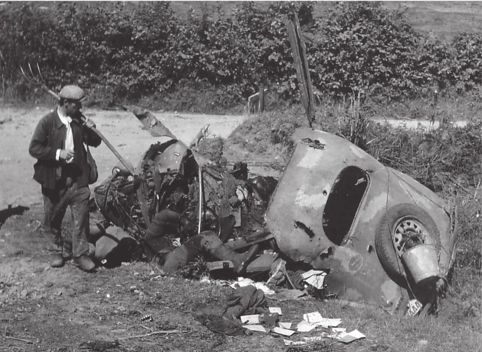  Caught on the open road, this staff car and its dead occupant once belonged to the 116th Panzer Division