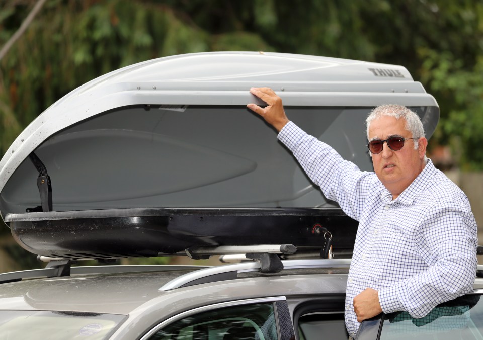  Simon Fenton, 57, shows his Skoda 4x4's roof box where he discovered a migrant speaking broken Dutch and German