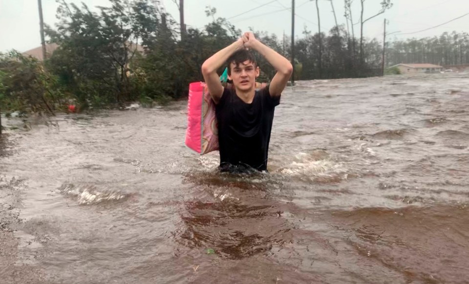  Matthew Aylen is rescued from a flooded home in Freeport, Bahamas