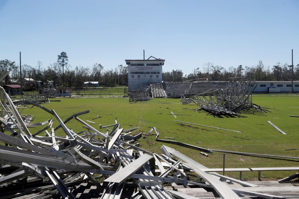  The seating and light poles lie mangled at this Florida high school football field