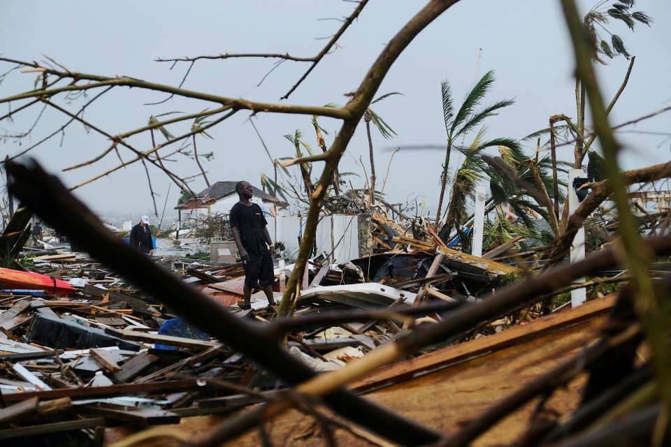  A man stands among the mangled wreckage in Marsh Harbour, Bahamas