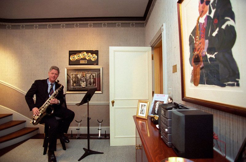 Former president Bill Clinton plays the saxophone in the music room, next door to the gym