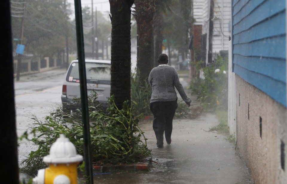  A woman braves the downpours in Charleston, South Carolina