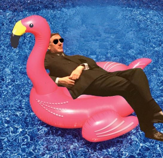  Rees-Mogg is seen reclining in an inflatable flamingo