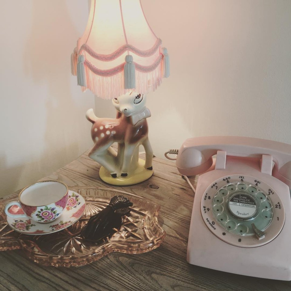  Dainty tea cups mingle with retro telephones and a Bambi lamp on a sideboard