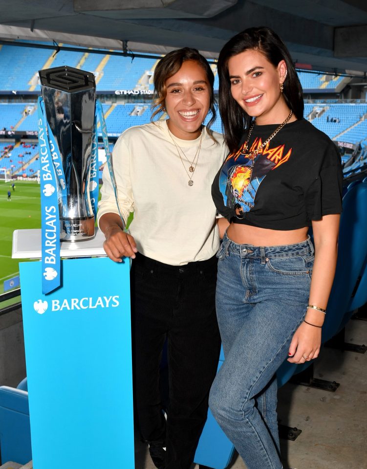  The two posed with the football trophy