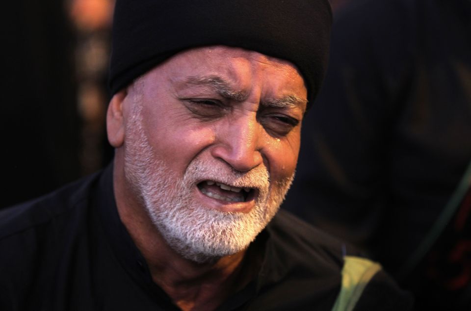  An Iraqi man cries as the events of the death of Husayn is reenacted