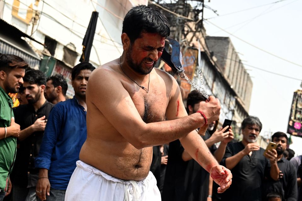  A man in New Delhi begins to beat himself