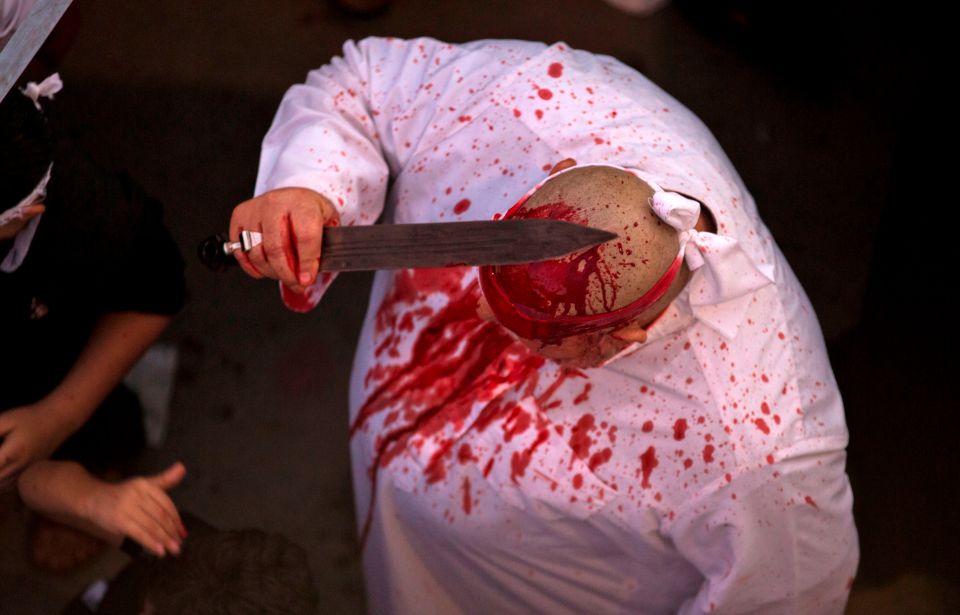  A man cuts his head in the city of Basra in southern Iraq