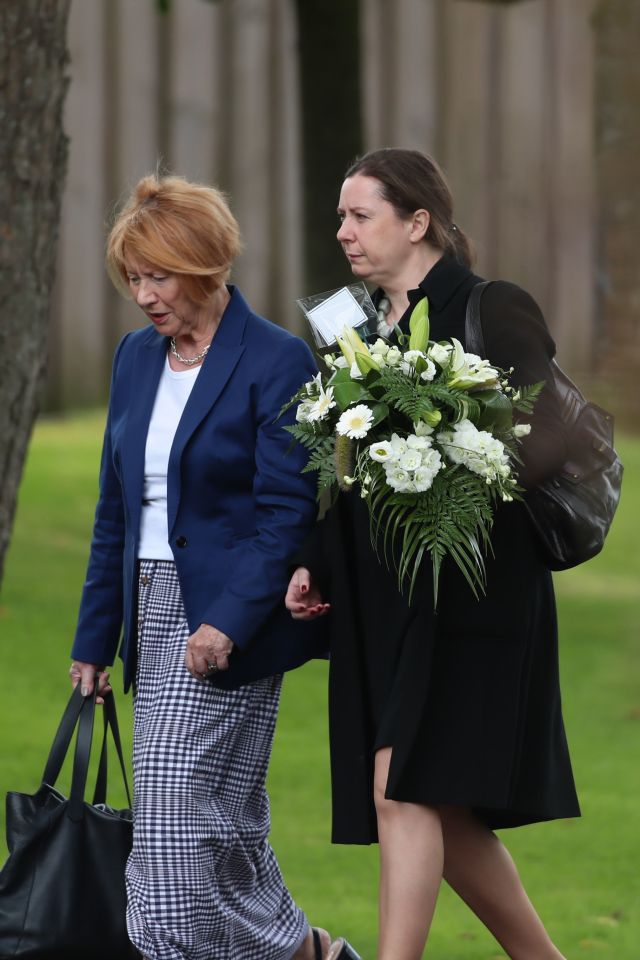  Mourners carry flowers as they pay their respects to Nora today