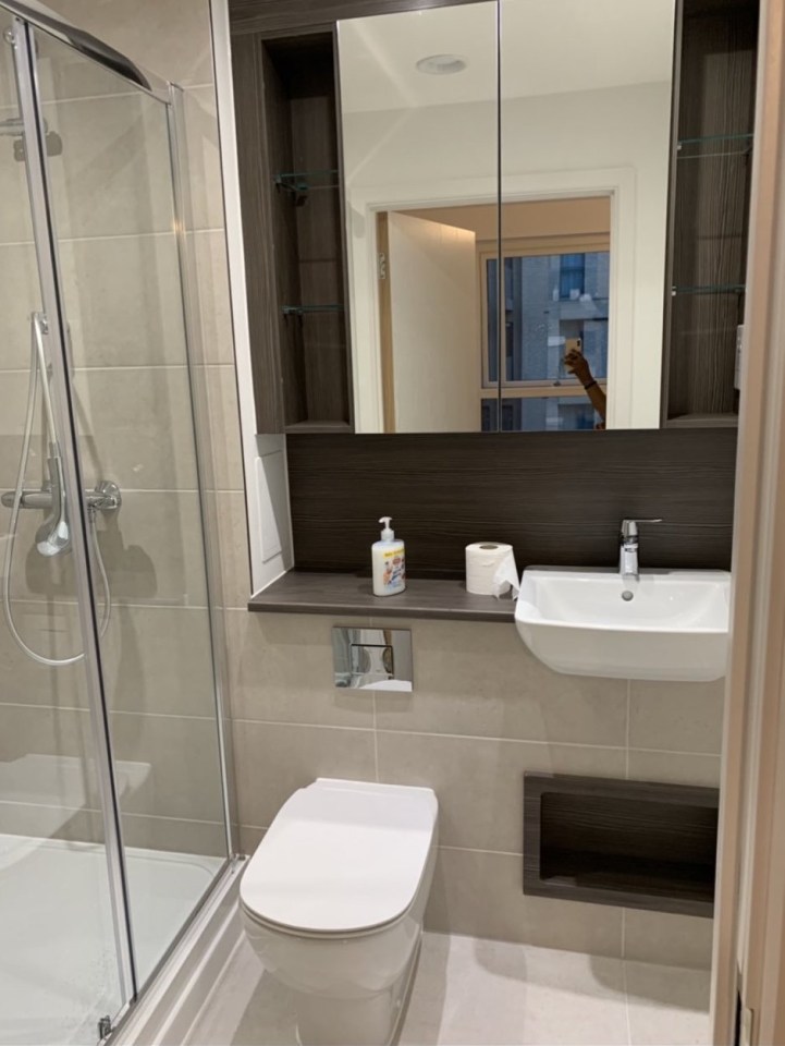  Her bathroom featured a shower and wooden shelves