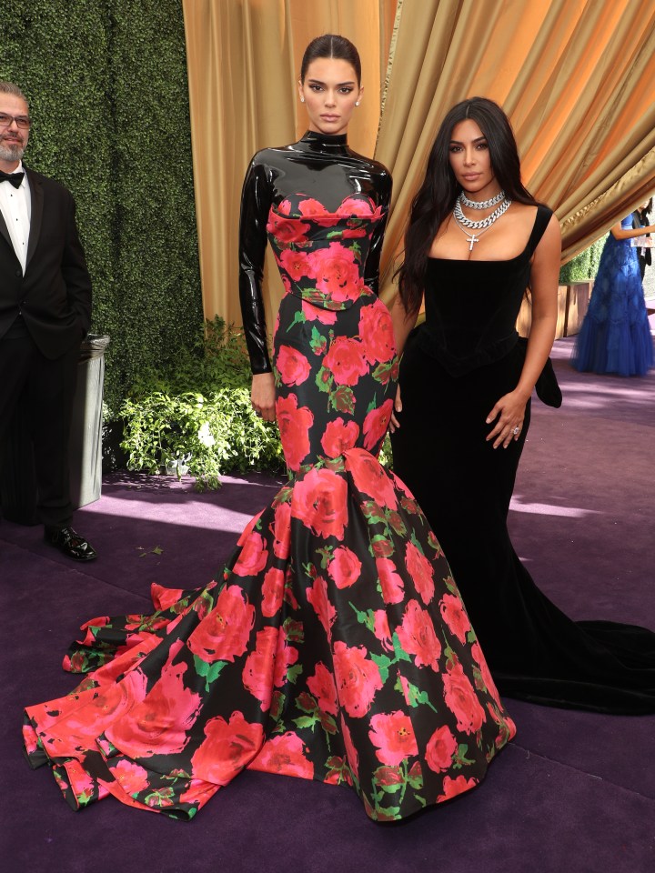  Sisters Kendall Jenner and Kim Kardashian stood out from the crowd with Kendall's floral Richard Quinn gown and Kim's tight-fitting Vivienne Westwood