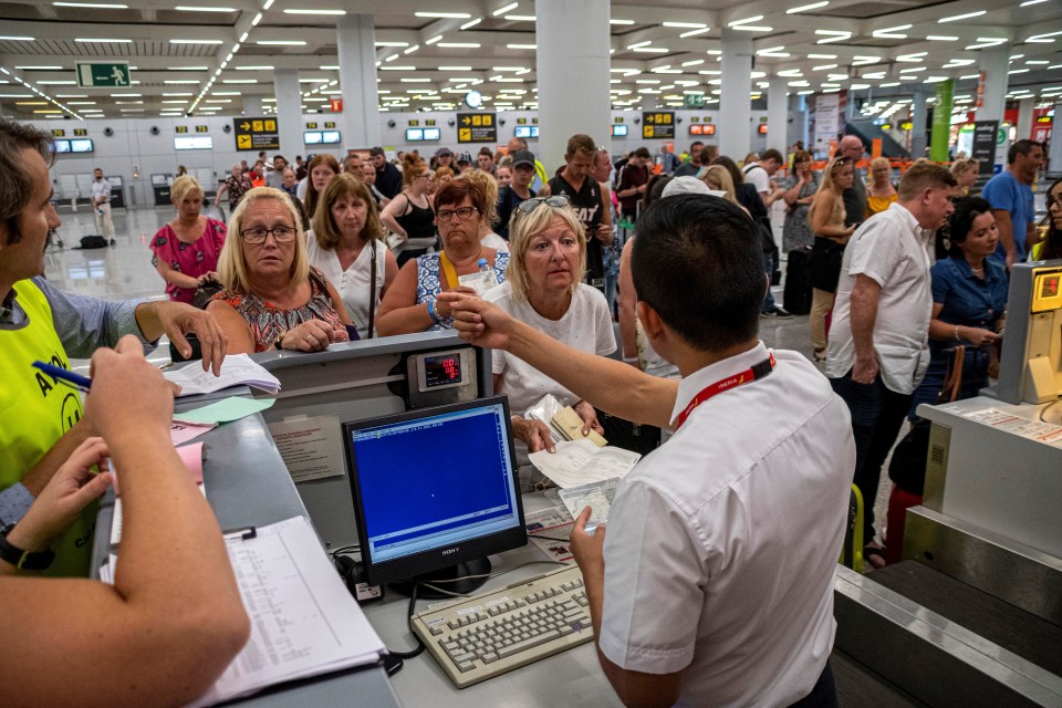  Passengers wait to be helped at Palma airport in the Balearic Islands, Spain