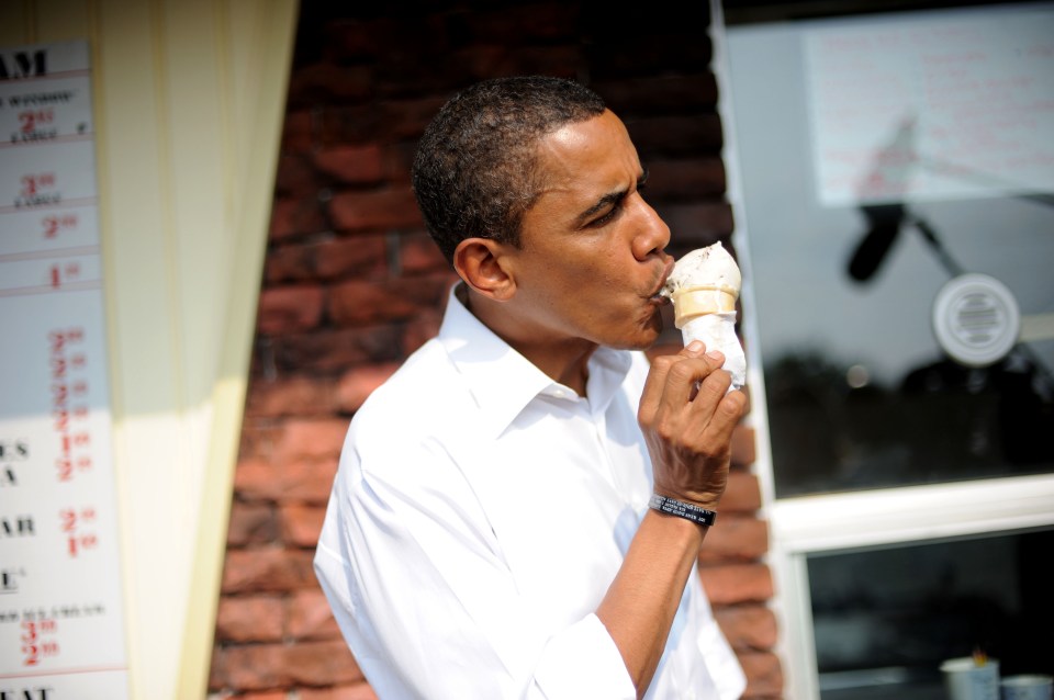  Former US president Barack Obama tucks into an ice cream