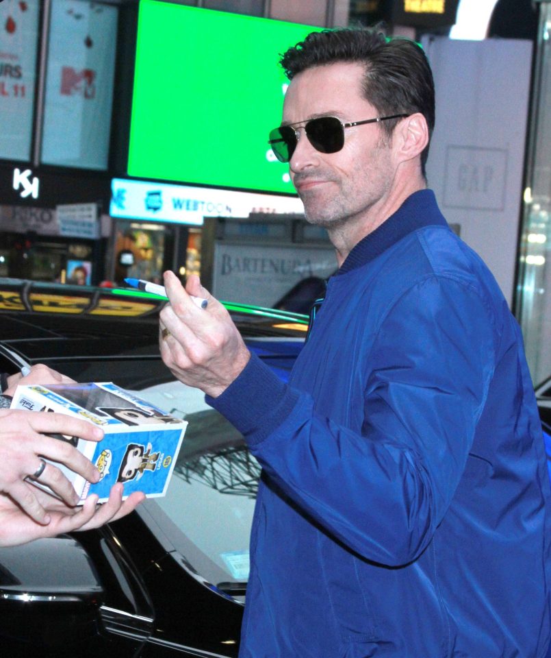  Left-handed actor Hugh Jackman signs autographs earlier this year