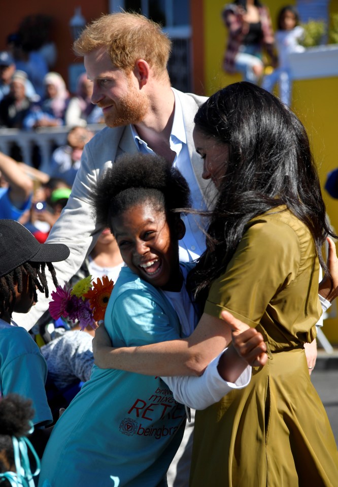  A young fan appears beside herself as she gets a hug