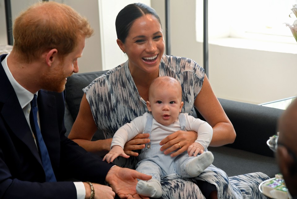  Meghan laughs as she holds baby Archie - saying the little boy is an 'old soul'