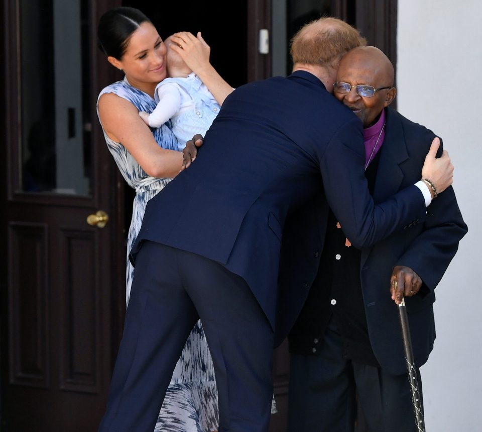  Prince Harry hugs the Nobel Prize winner as Meghan smiles with Archie in her arms