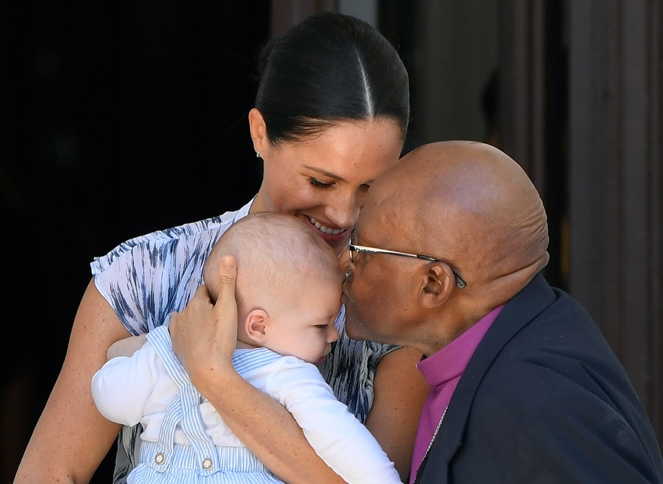  Archbishop Desmond Tutu gives the four-month-old a sweet kiss on his head