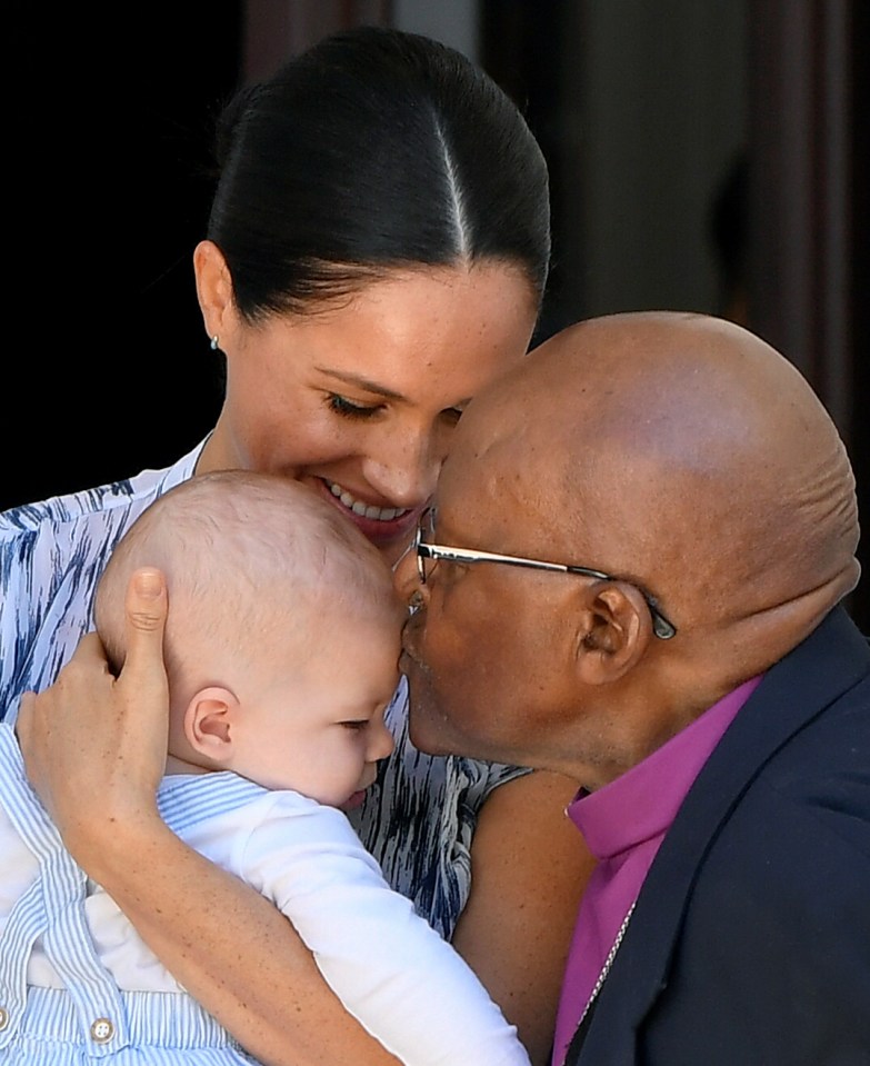  Meghan smiled as Archbishop Tutu kissed baby Archie's forehead in another adorable moment