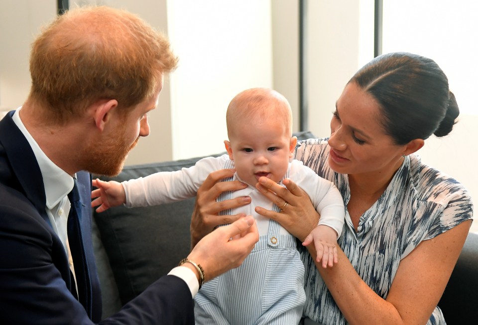  The doting parents kept a close eye on their little one