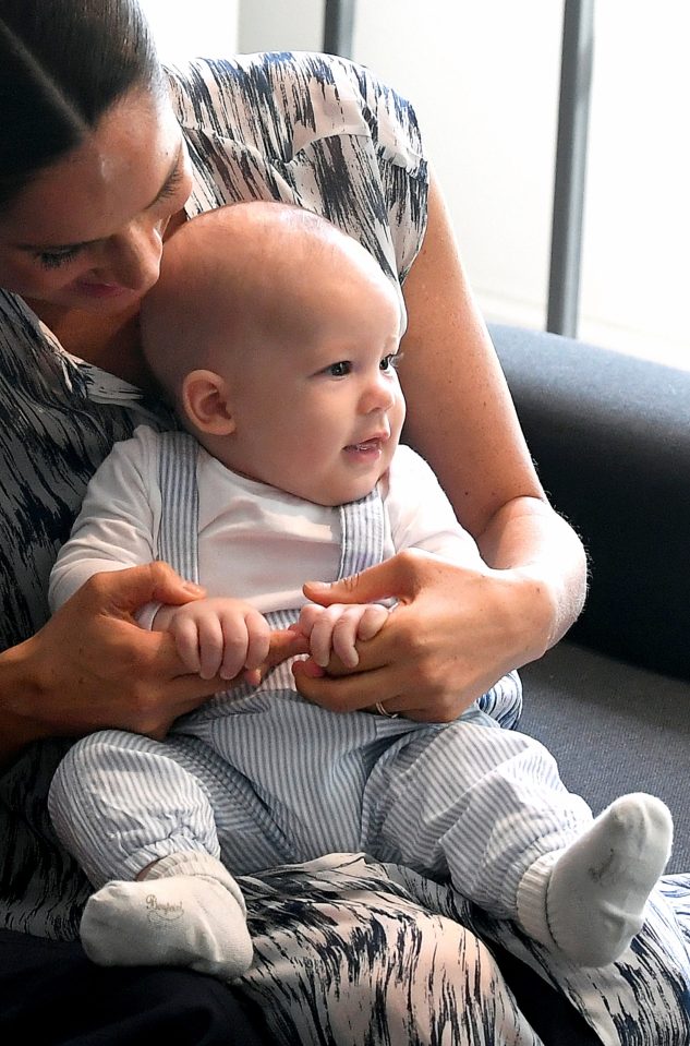  Little Archie wraps his fingers around mum