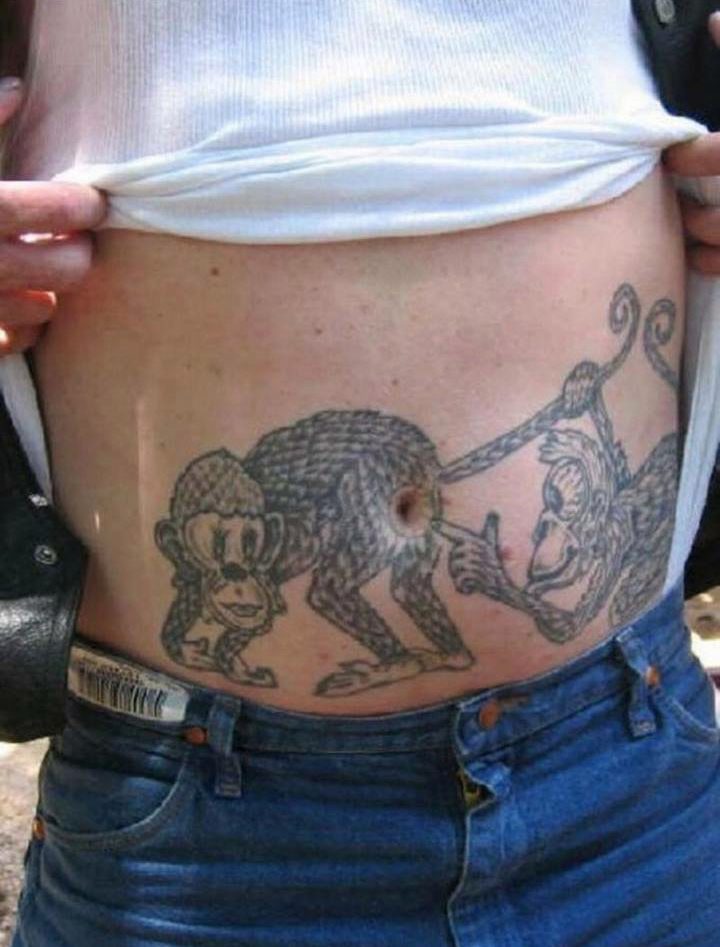  Two monkeys tattooed on this man's stomach goof around on his belly button