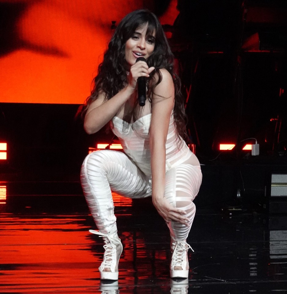 Havana singer Camila Cabello wears a figure-hugging white jumpsuit on stage in Miami