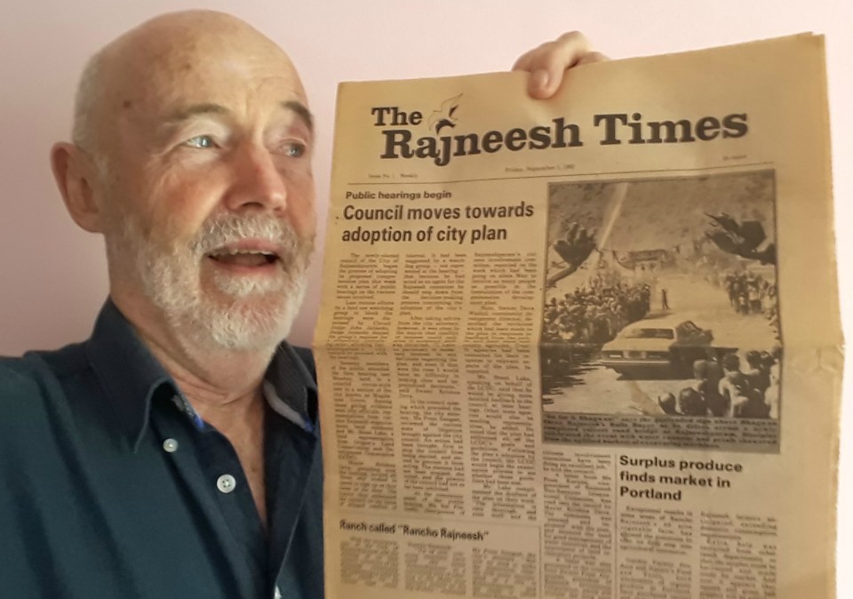 Author Subhuti poses with a copy of The Ragneesh Times