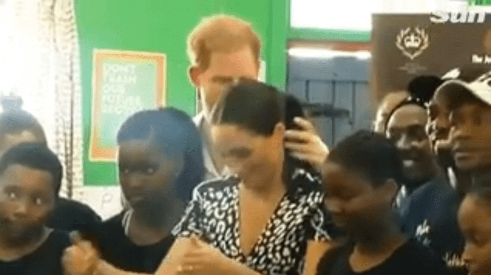  The Duke of Sussex was spotted "lovingly" smoothing his wife's ponytail during a trip to the township of Nyanga