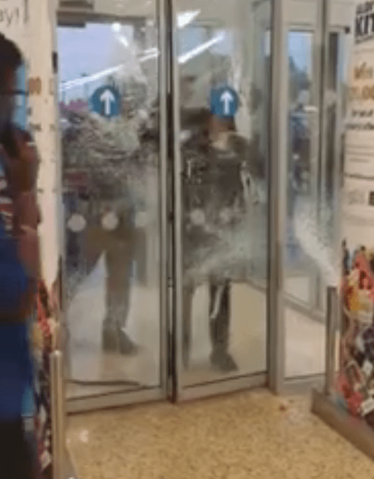  At least two youths were filmed trying to smash the doors and get into the shop last night