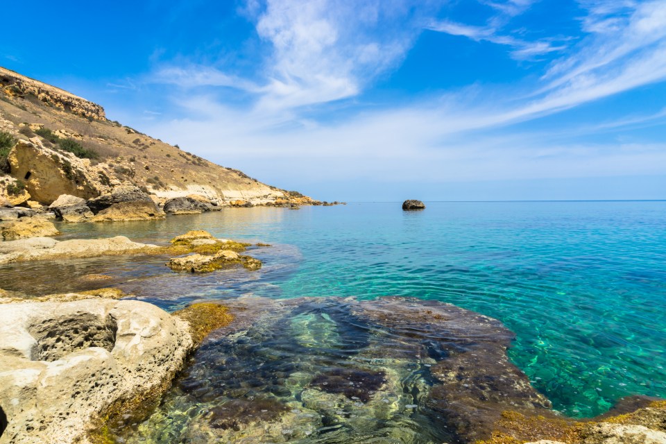 Explore the rocky coastline of Gozo along the Mediterranean sea