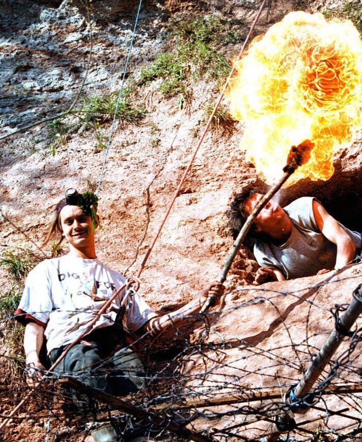  Swampy, left, has his torch lit by fellow campaigner after abseiling down a cliff on the site of the proposed second runway at Manchester airport